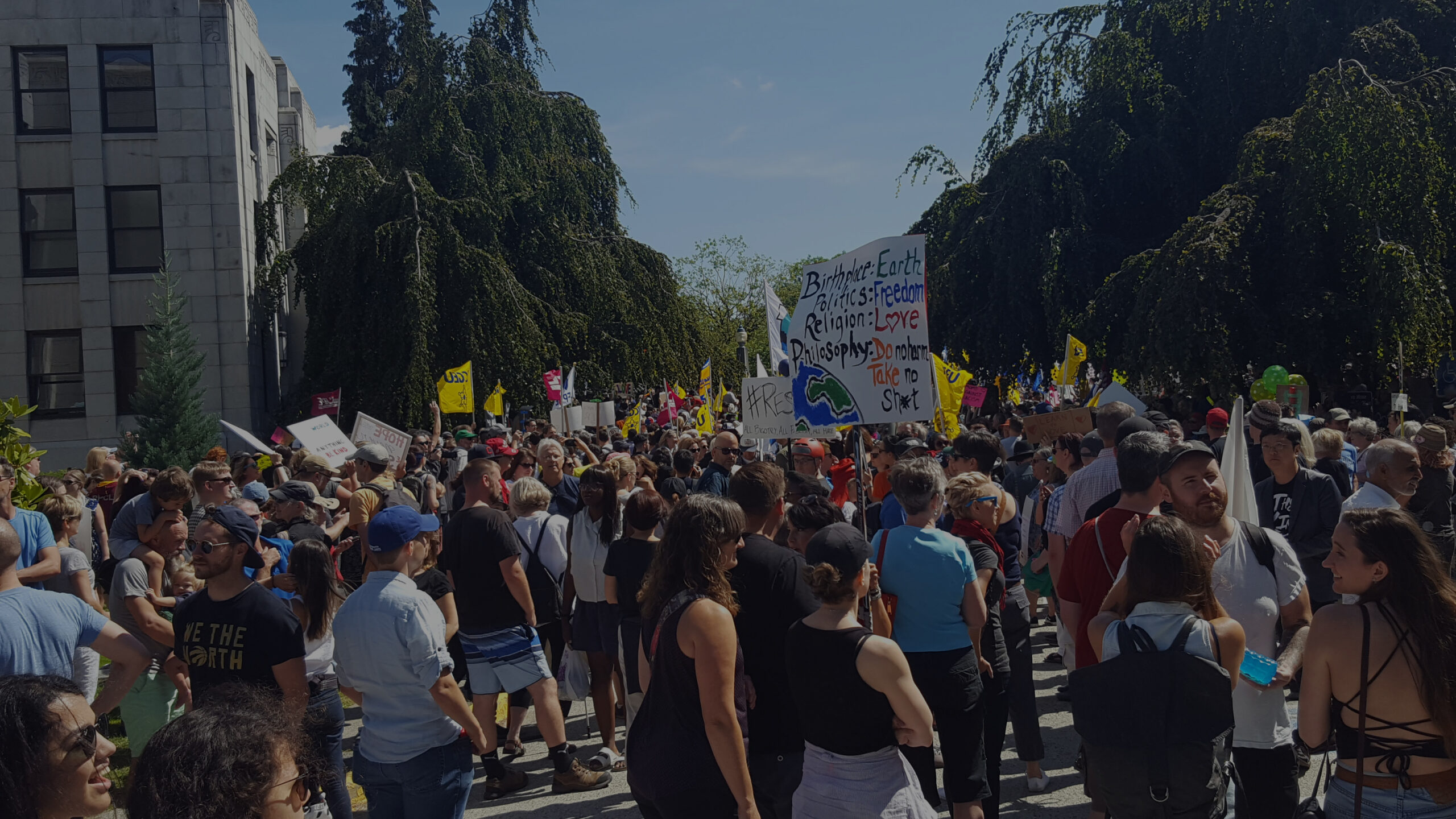 Crowd of people protesting at Vancouver city hall